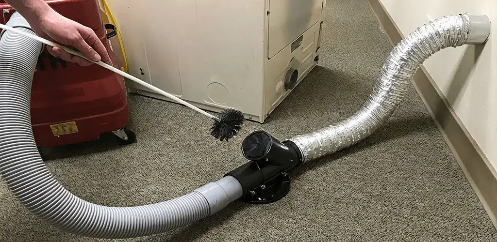 Dryer vent cleaning service removing lint from a dryer duct connection in Oakland, CA