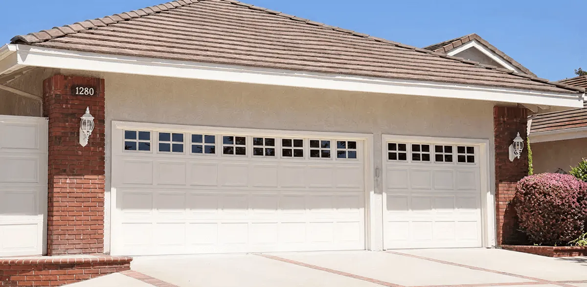 Residential garage door repair service for a double garage door in Oakland, CA
