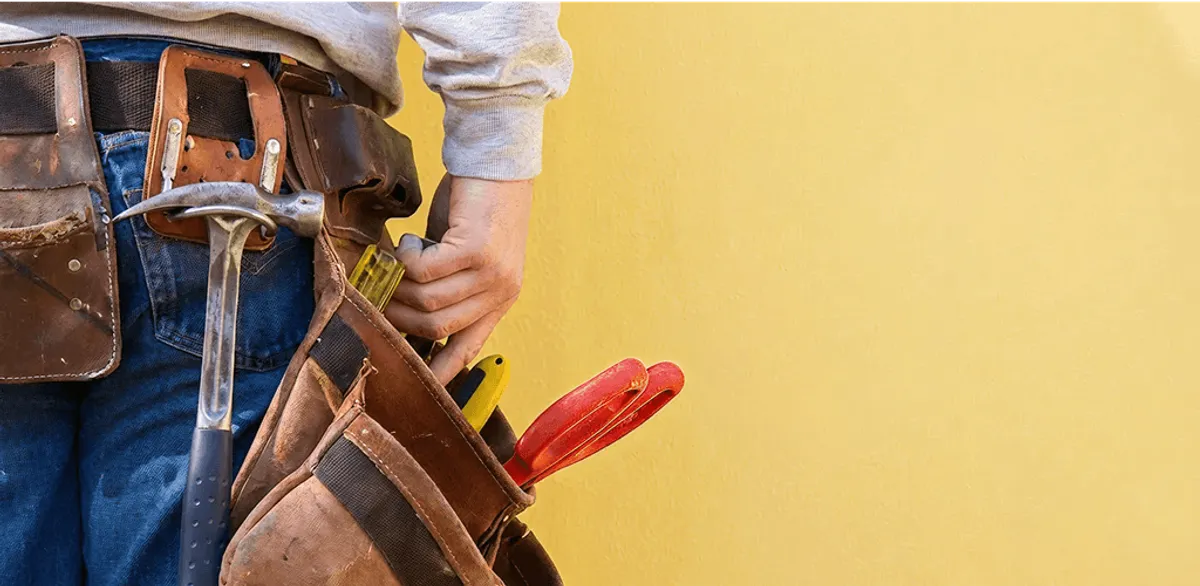 Handyman with tool belt ready for home repairs and maintenance in Oakland, CA