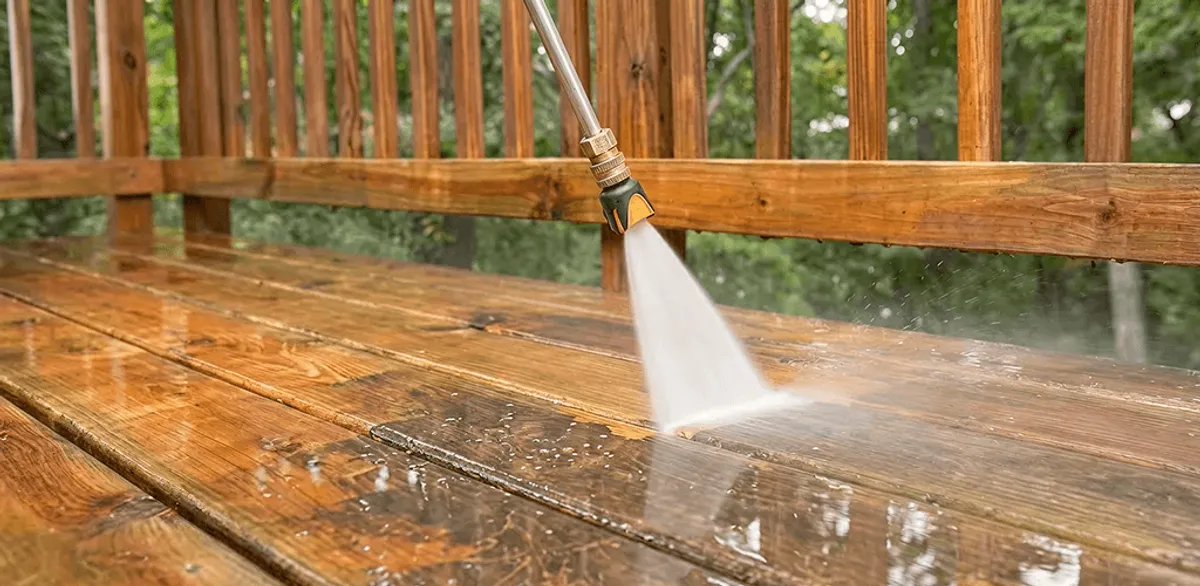 Pressure washing a wood deck to remove dirt and buildup in Oakland, CA
